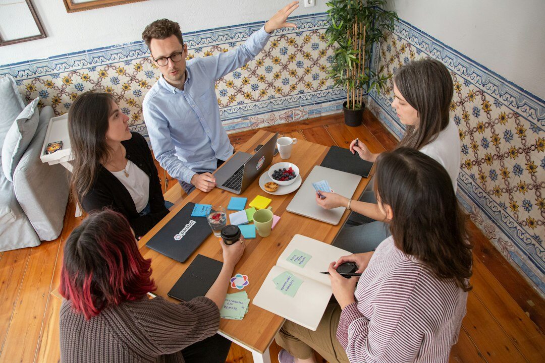 man leading team meeting